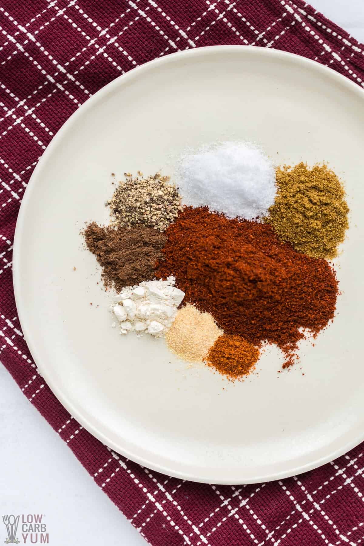 an assorted of spices on a place to make homemade chili seasoning