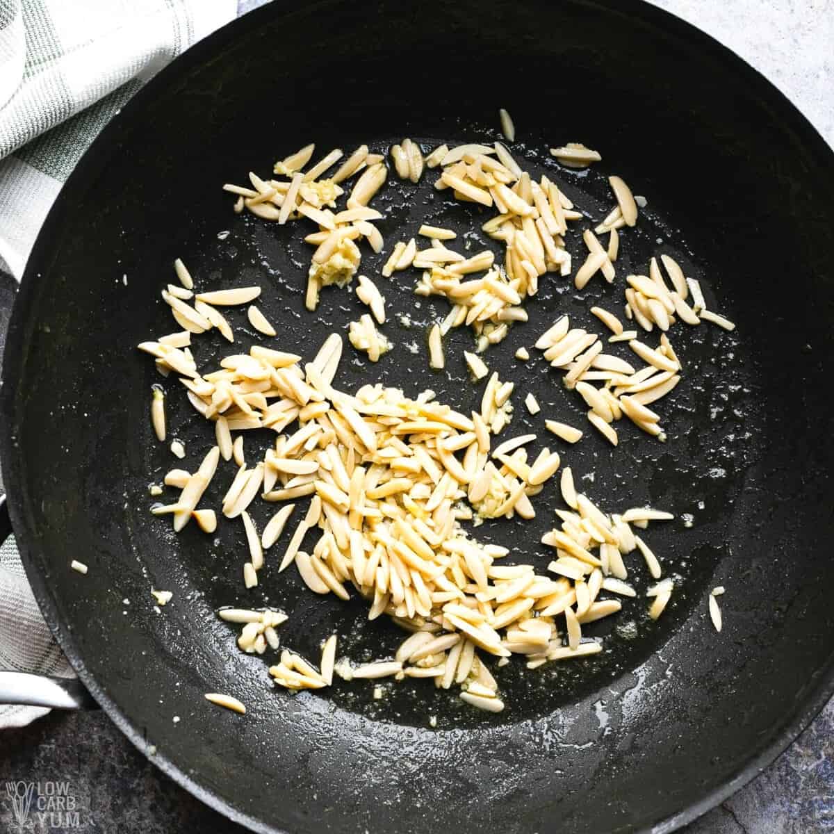 slivered almonds and garlic in skillet