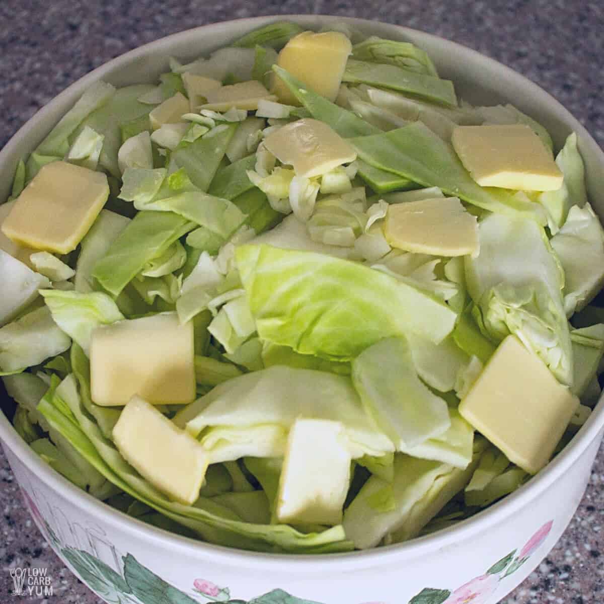 cabbage in round casserole dish with butter pieces on top