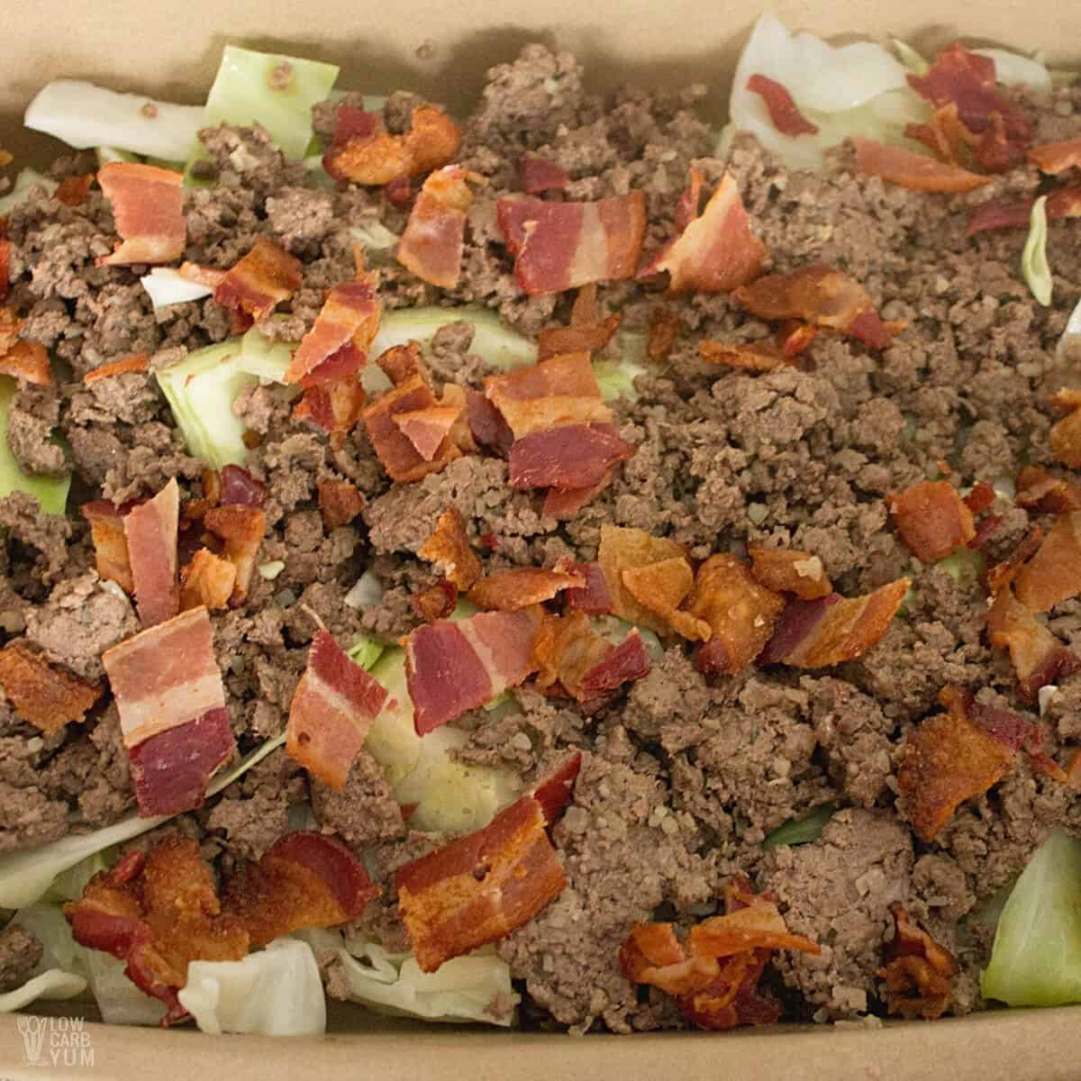 ground beef and bacon layer in casserole pan