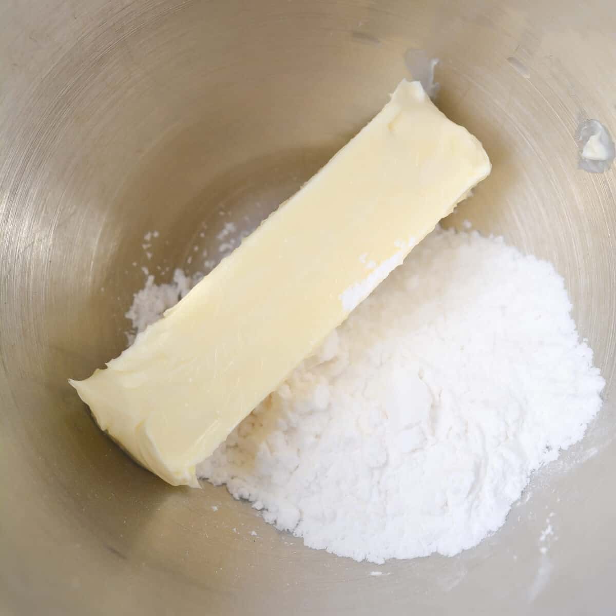 unsalted butter and sweetener in mixing bowl
