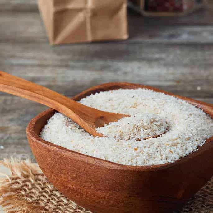 psyllium husks in wood bowl with spoon