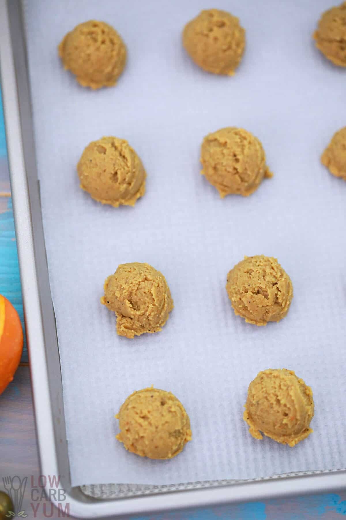 forming the pumpkin ball filling on lined baking sheet