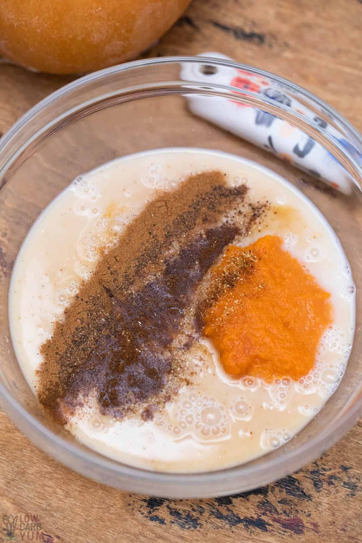 milk pumpkin vanilla and spices in mixing bowl
