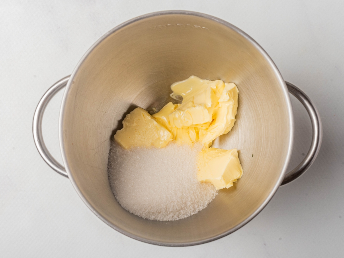 adding butter and sugar in a mixing bowl to cream