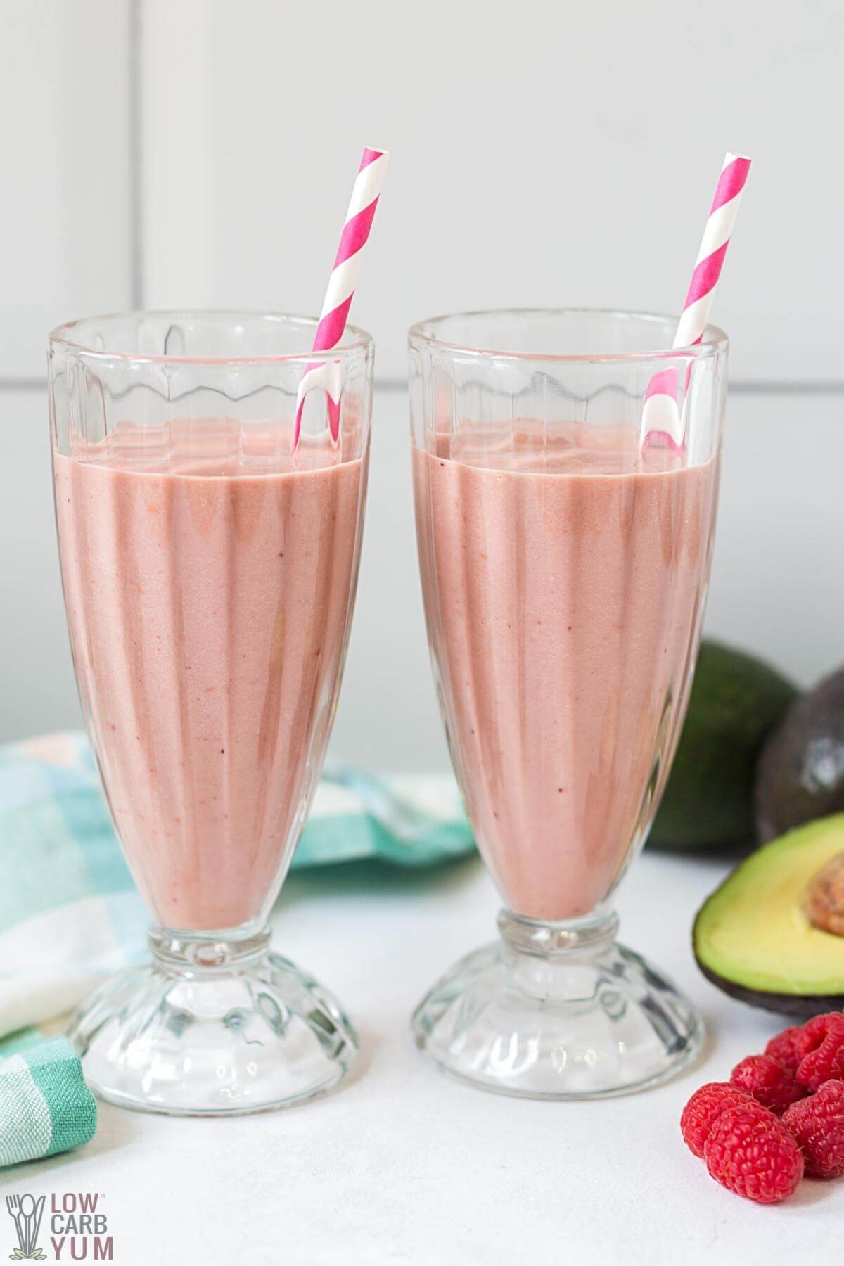 avocado smoothies with striped straws in tall glasses
