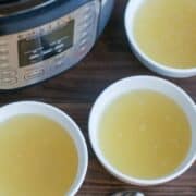 three small white bowls of bone broth with instant pot