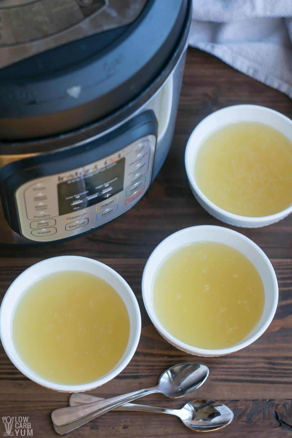 chicken bone broth in three small white bowls with instant pot