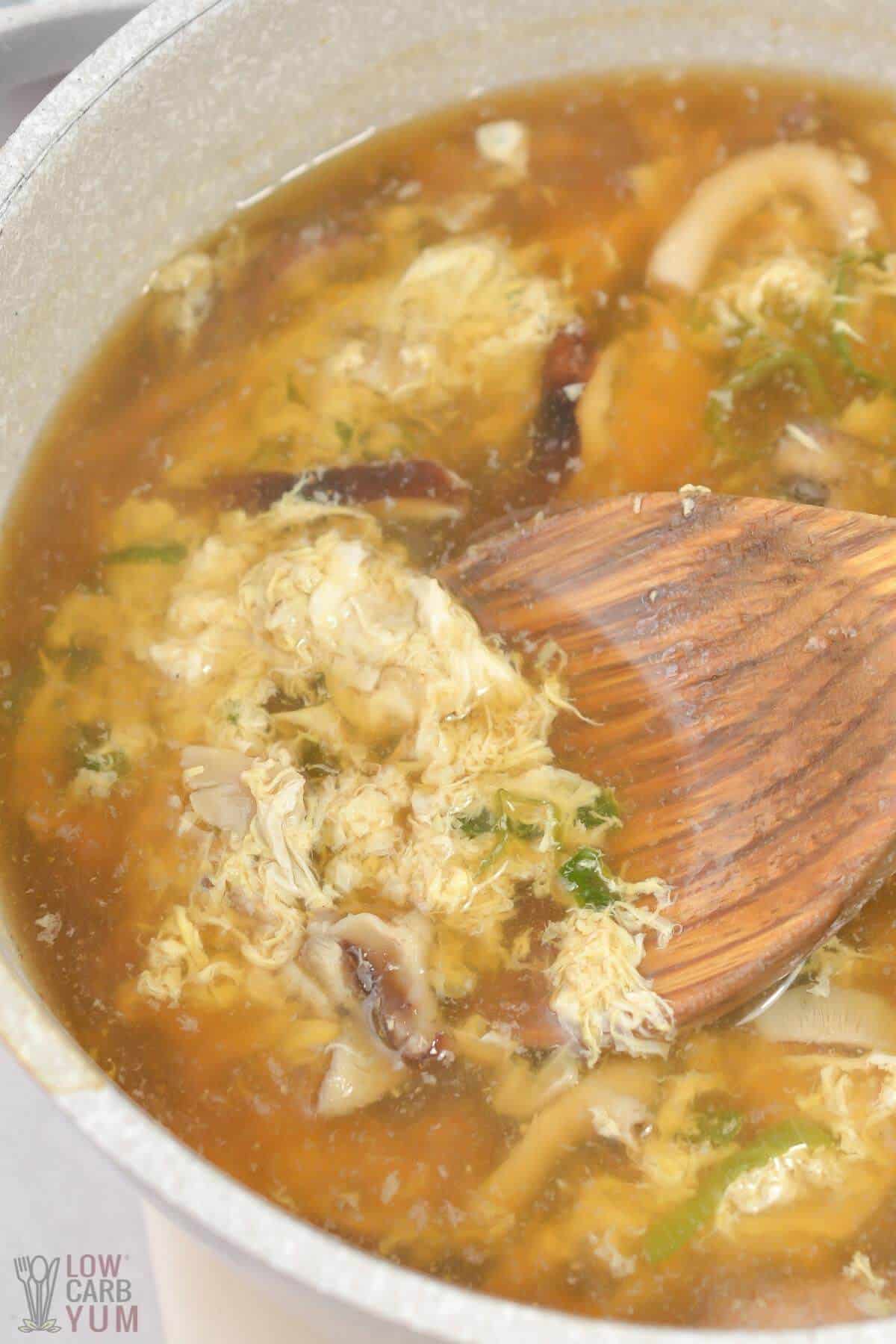 stirring beaten egg into the soup