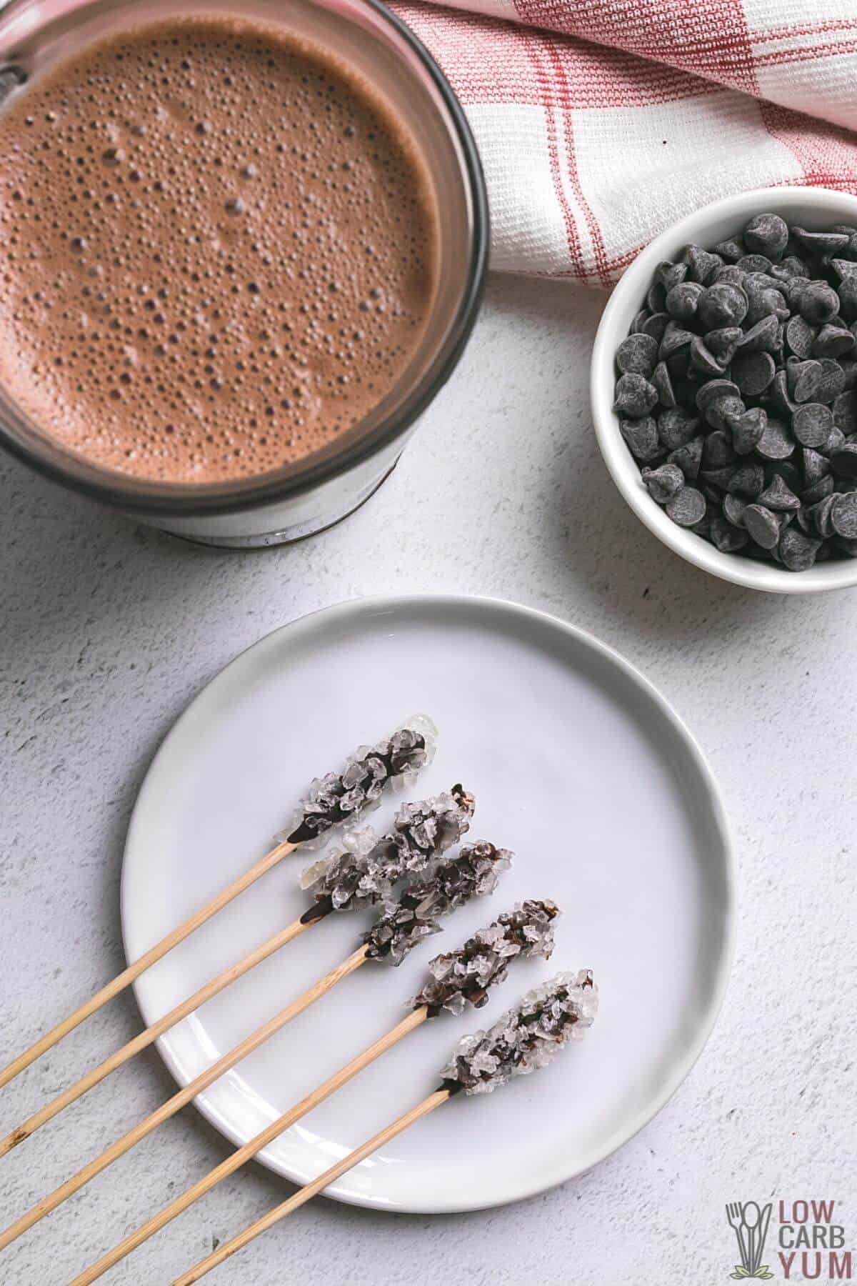 hot chocolate stirrers with chocolate chips and cup of cocoa