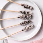 hot chocolate stirrers on white rimmed plate overhead shot