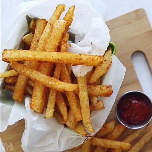 jicama fries in parchment paper lined basket with ketchup