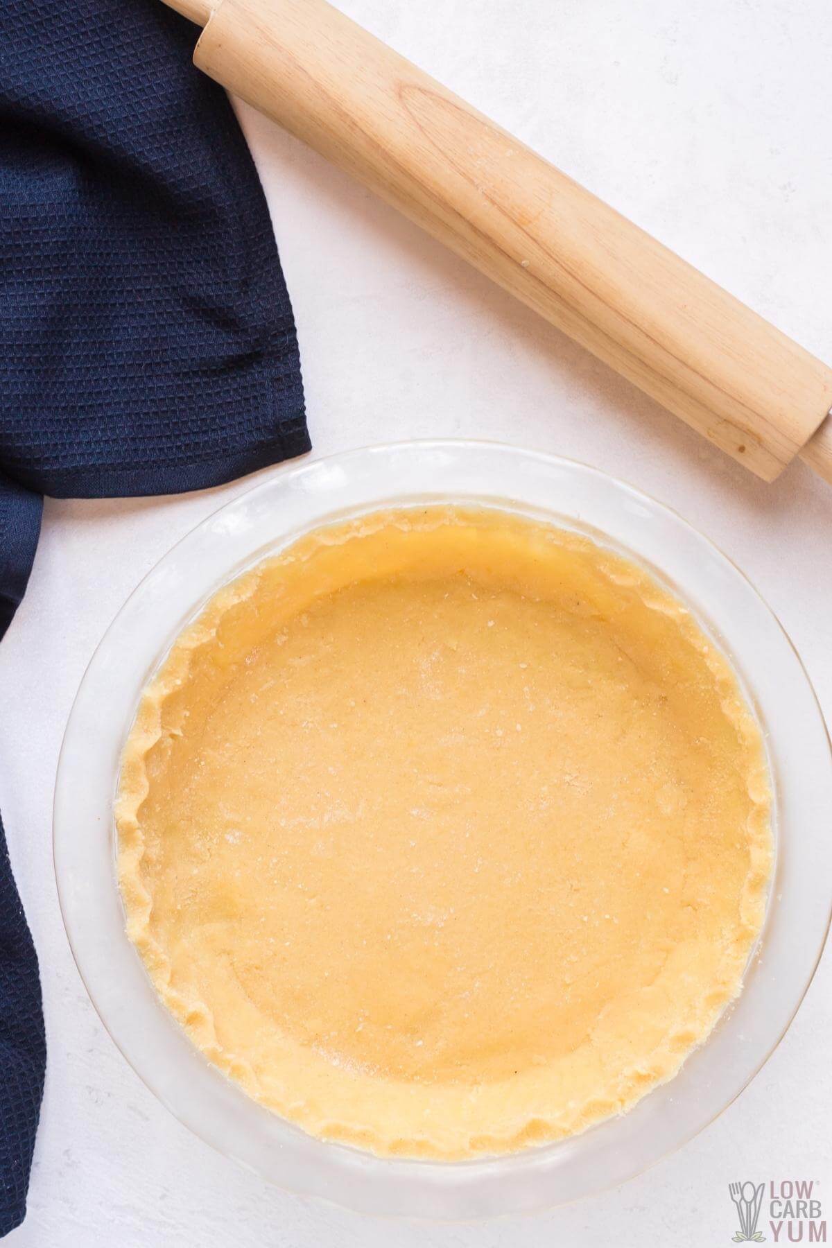 unbaked keto low carb pie crust with rolling pin