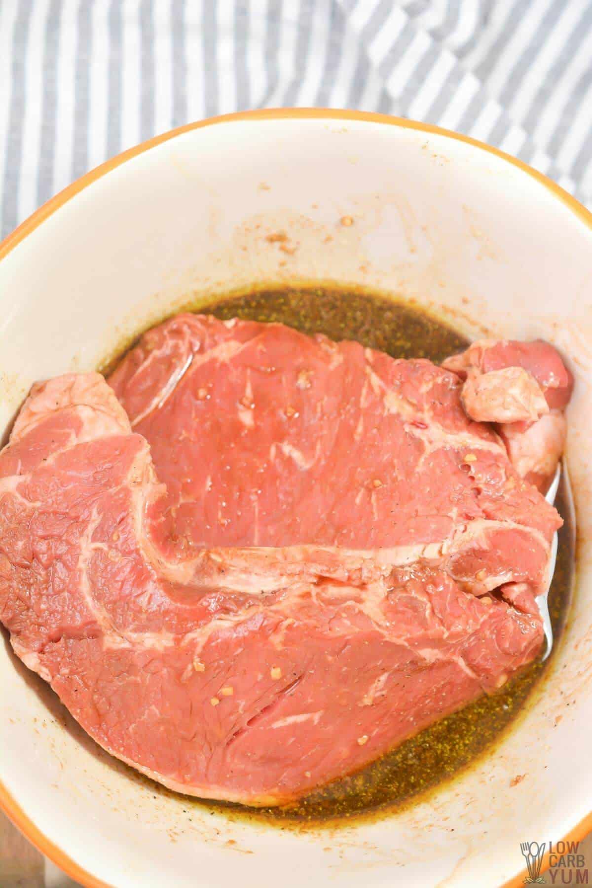 marinating a steak in bowl