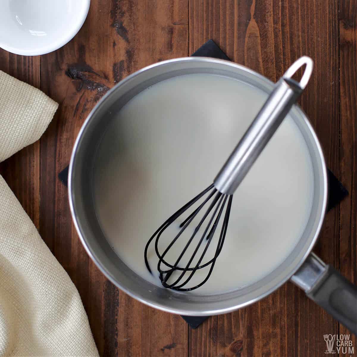 whisking the hot white chocolate drink in pot