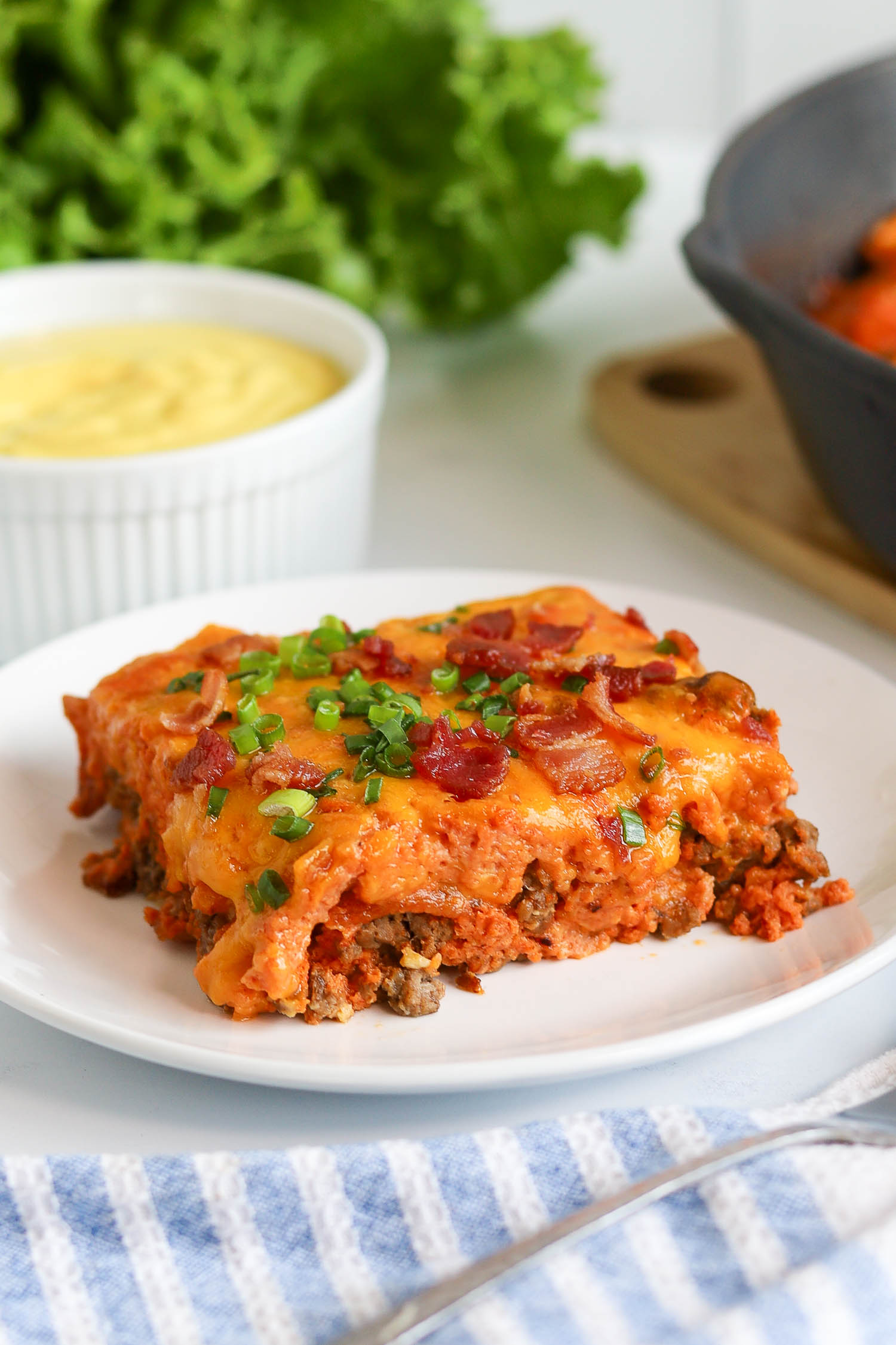 a slice of bacon cheeseburger casserole on a white plate