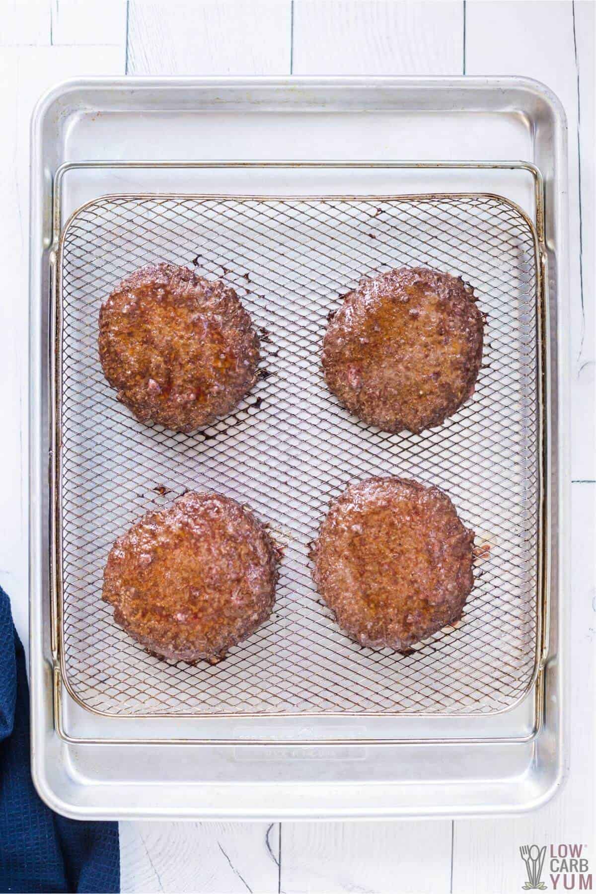 air fryer hamburger patties cooked on basket