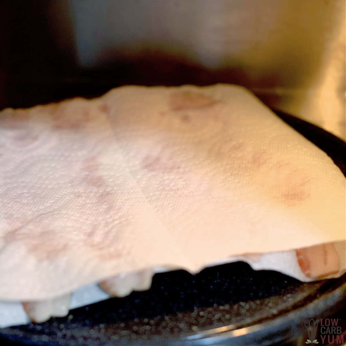 bacon covered with paper towel in microwave