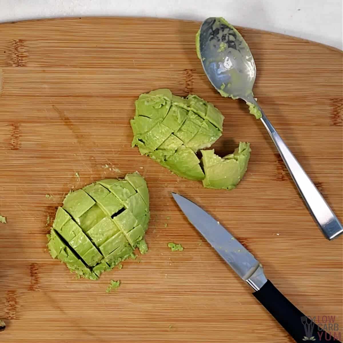 avocado cut in cubes on cutting board