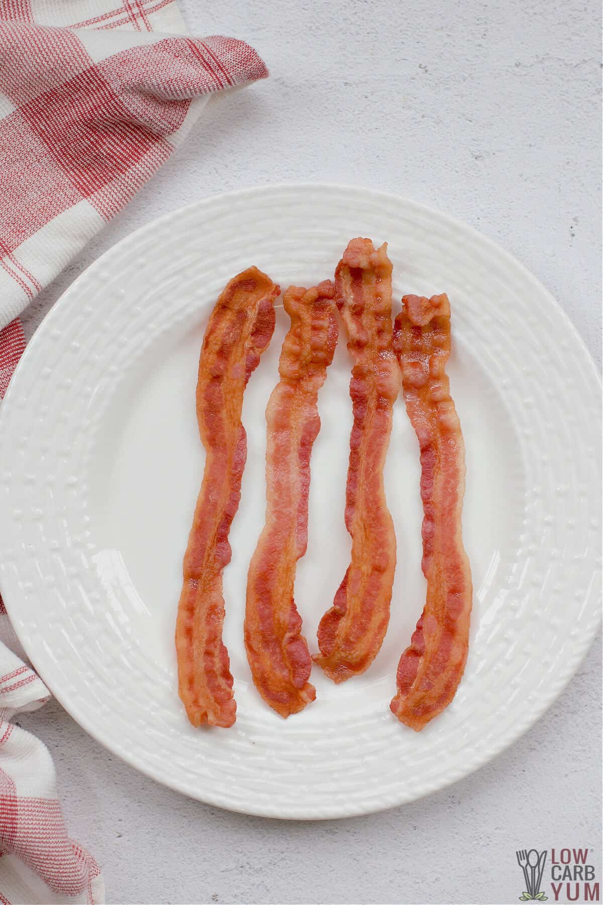 bacon cooked in microwave on white plate
