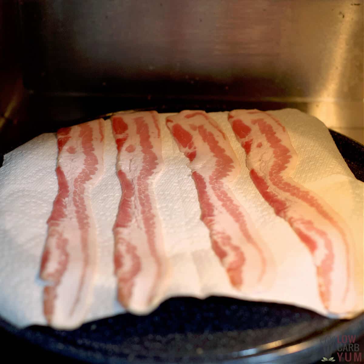 raw bacon strips in microwave on paper towel lined plate