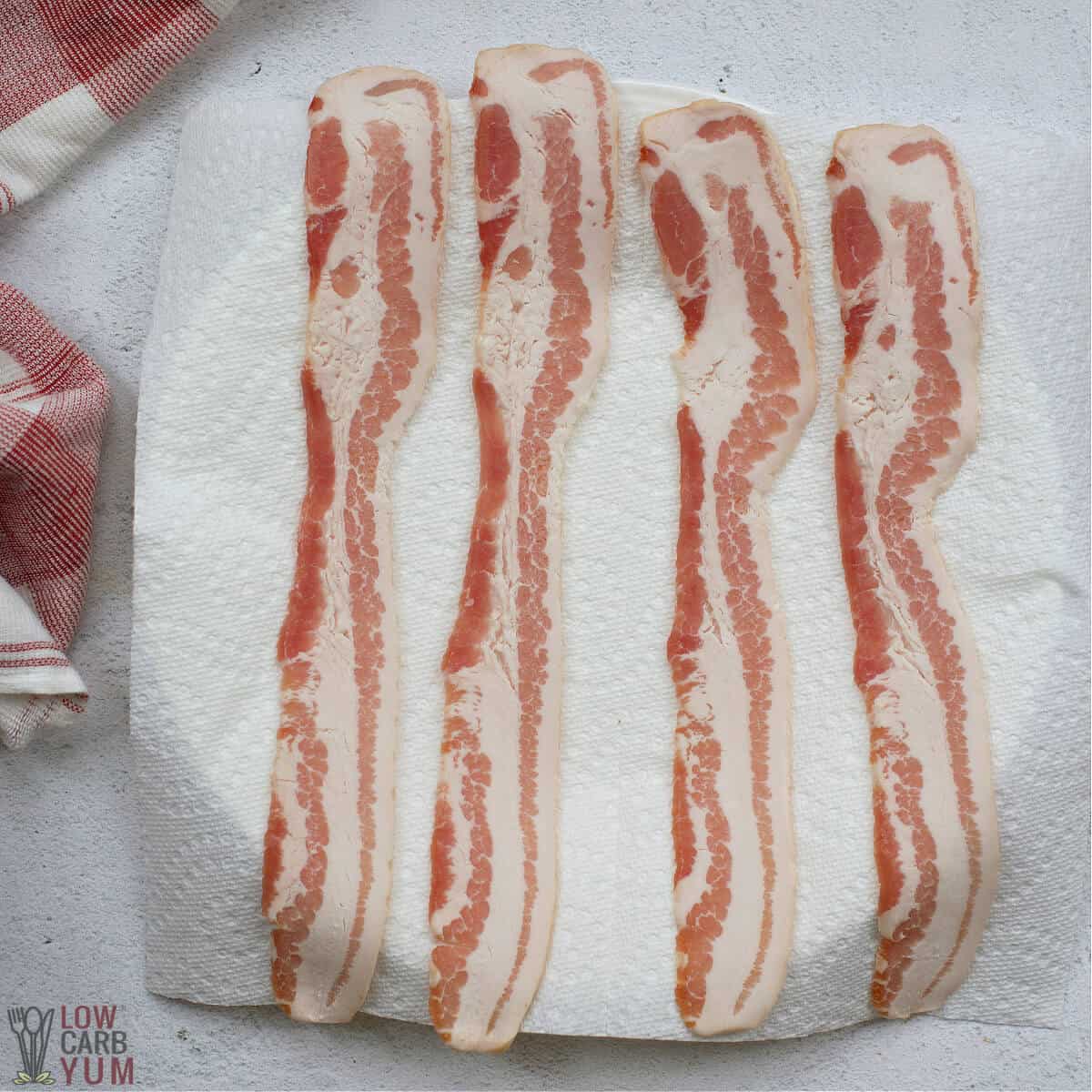 raw bacon on paper towel lined plate