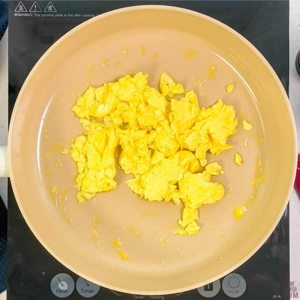 cooked scrambled eggs in skillet