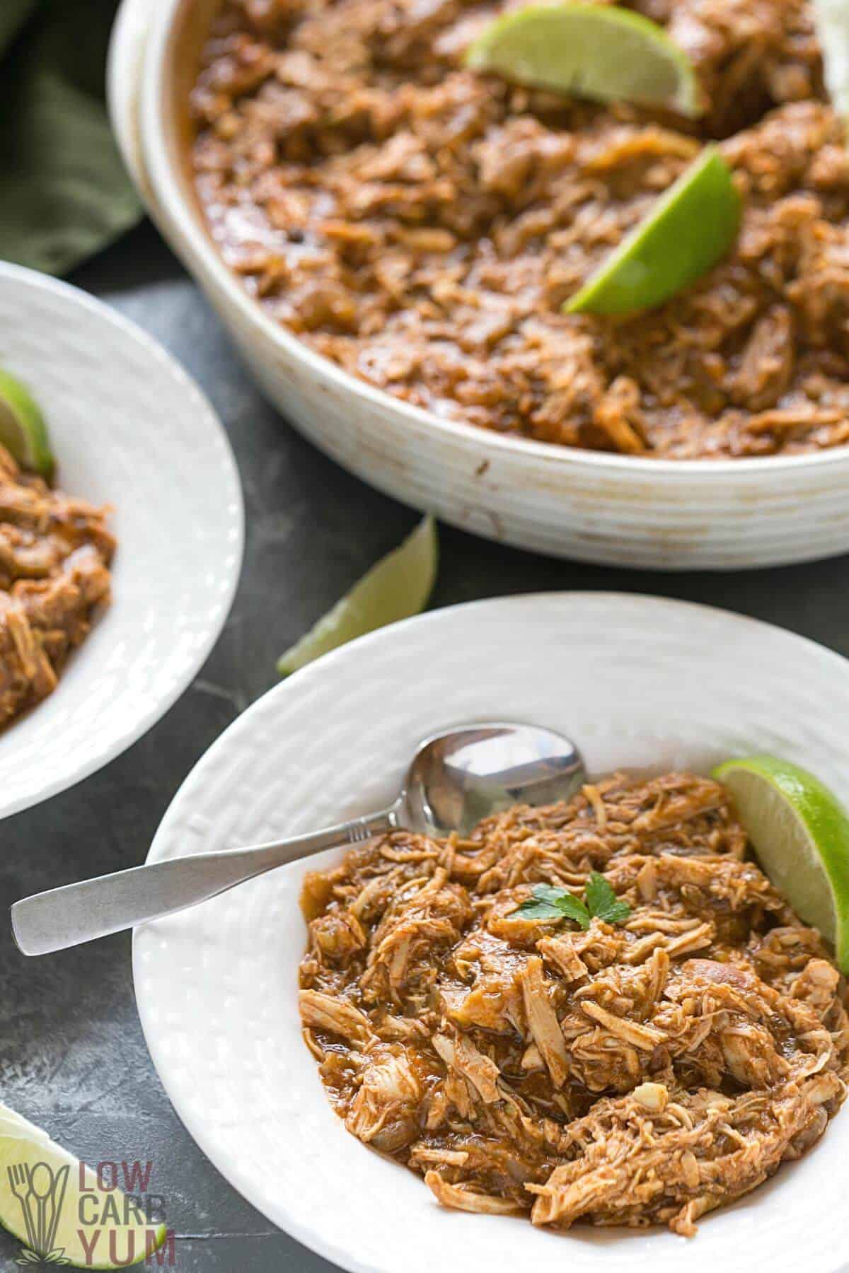 slow cooker salsa verde chicken breast shredded dinner in serving dish and serving bowl