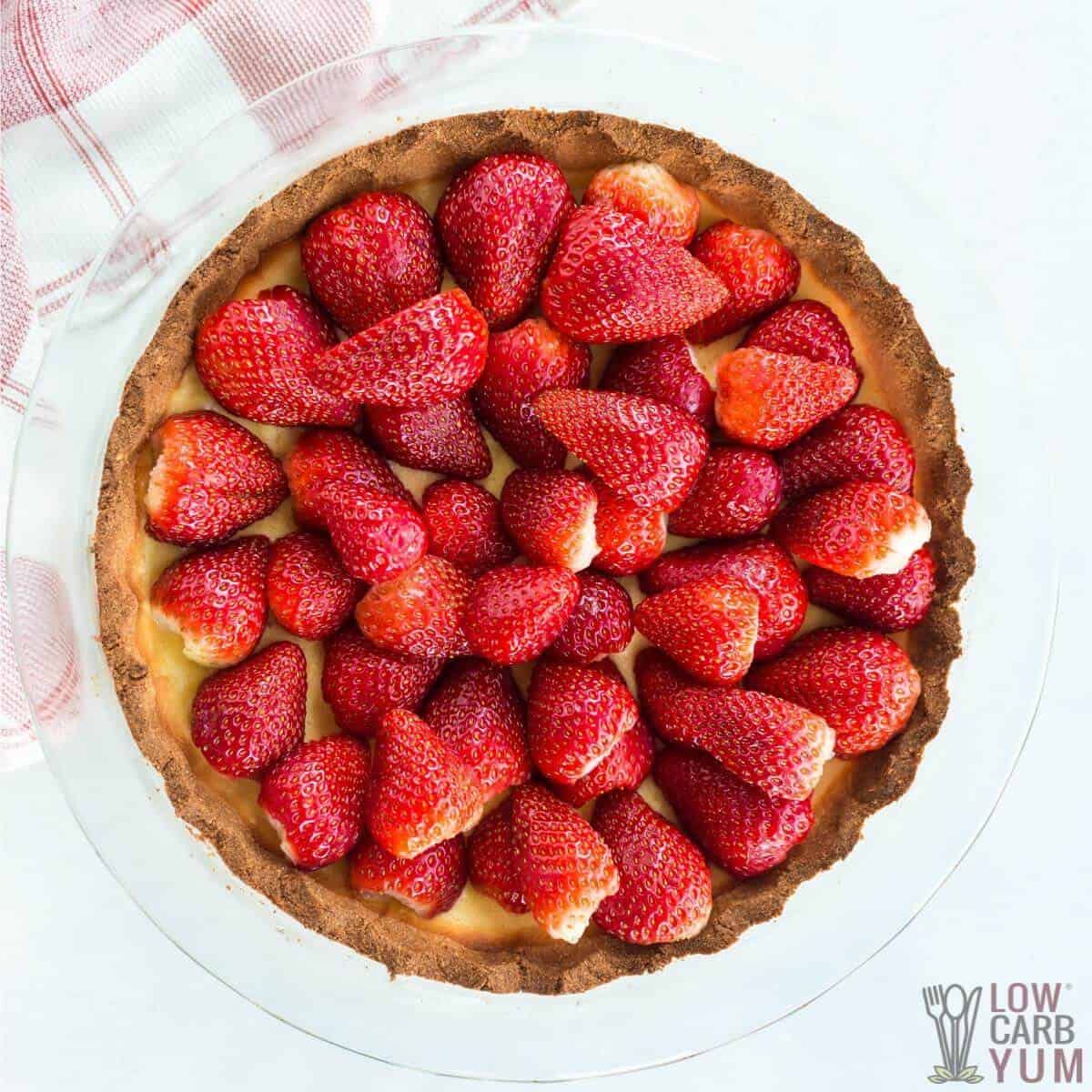 cut berries arranged on top of baked dessert