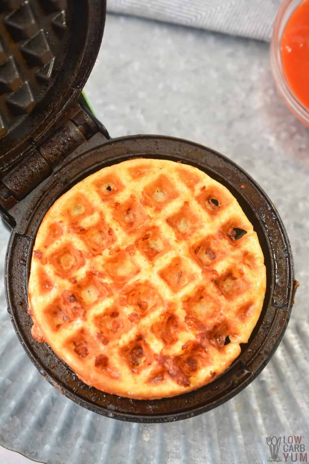 cheese and egg mixture cooking in mini waffle maker