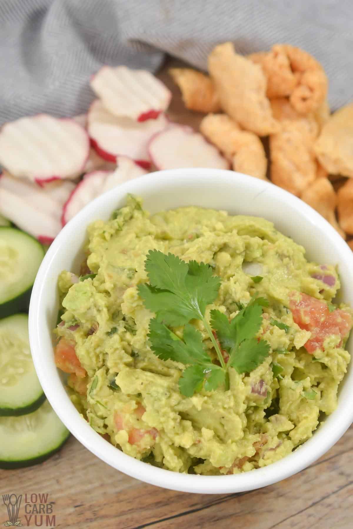 keto guacamole with cucumber radish and pork rinds.