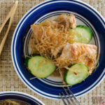 kelp noodle recipe with pork on white and blue plate