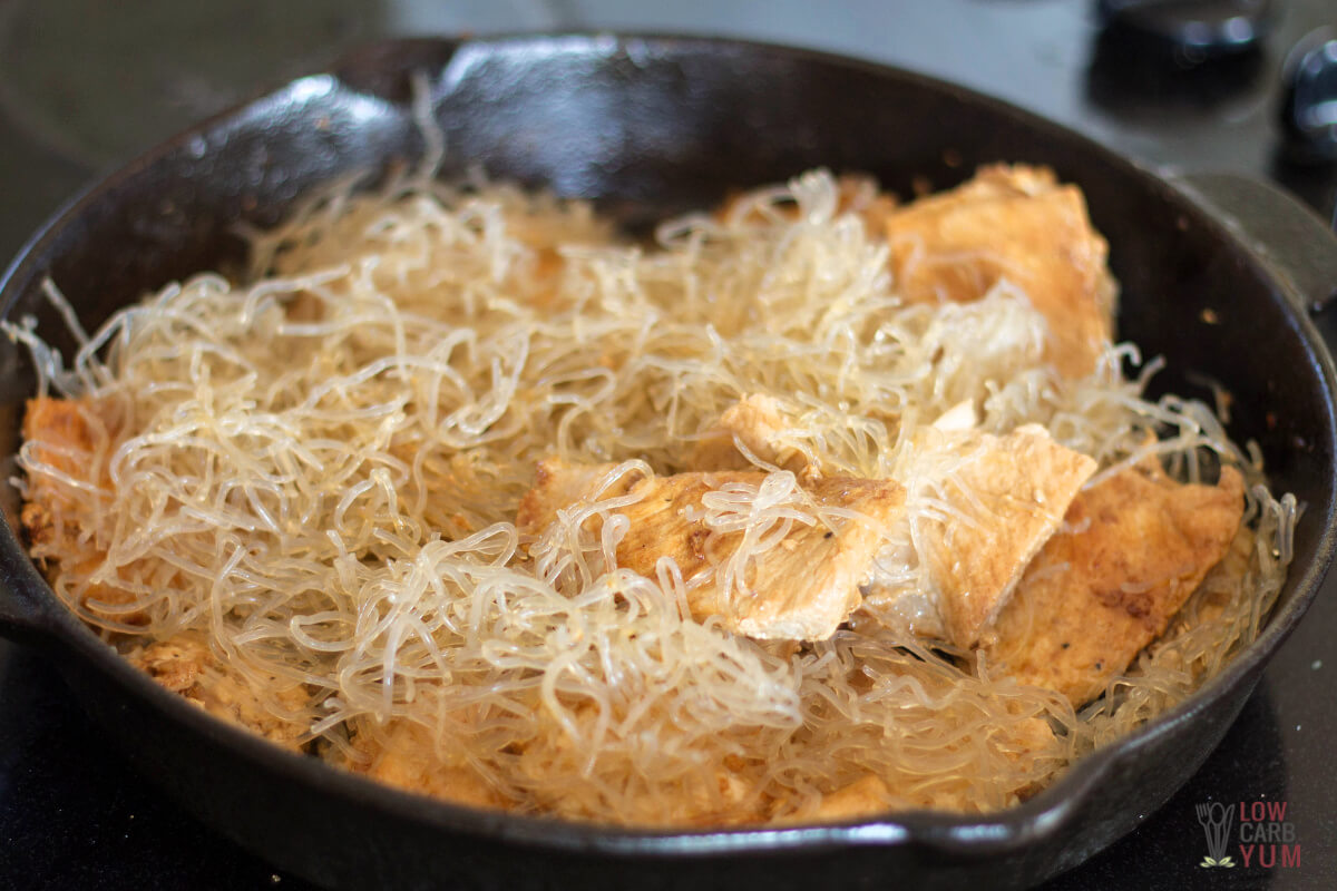 kelp noodles added to the pork in skillet