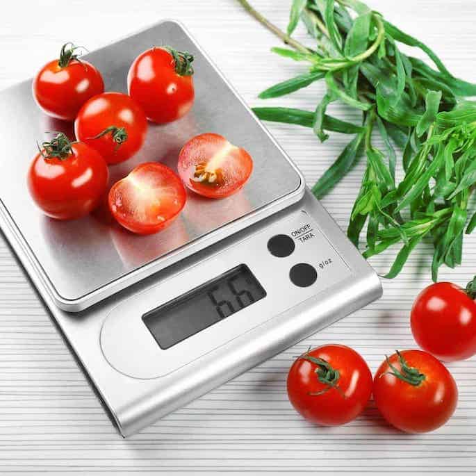 measuring cherry tomatoes on kitchen scale