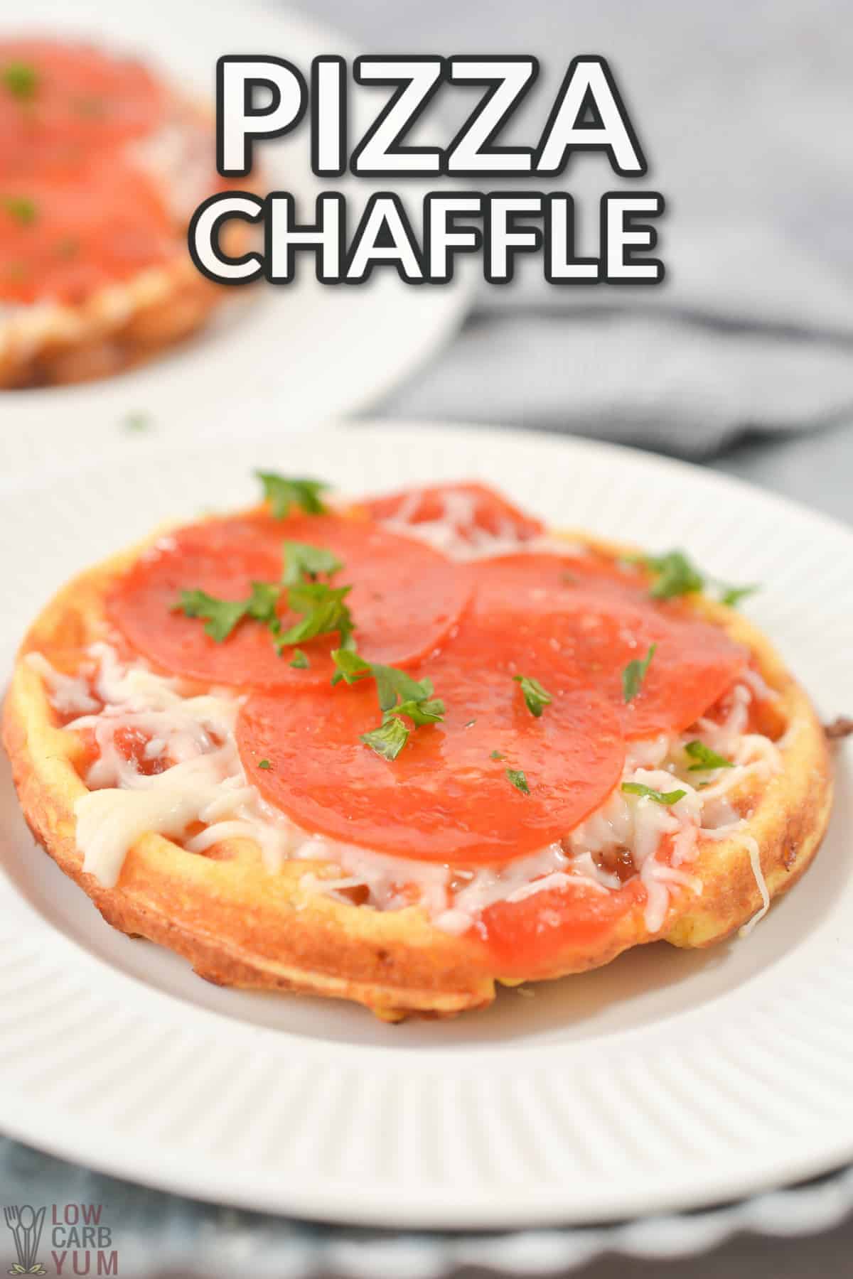 pizza chaffle on white plate with text overlay.