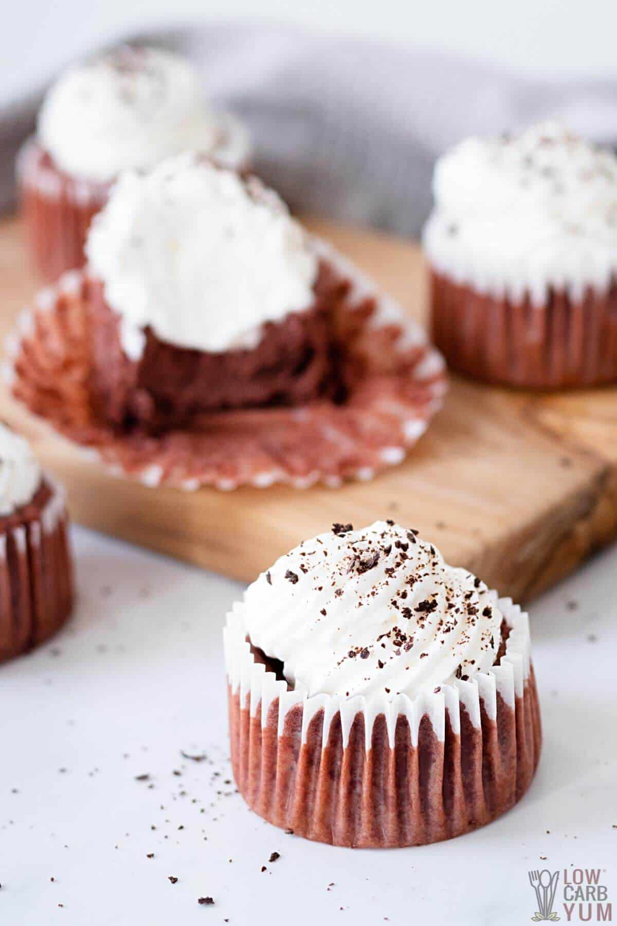 red velvet cheesecake cupcakes on cutting board and table