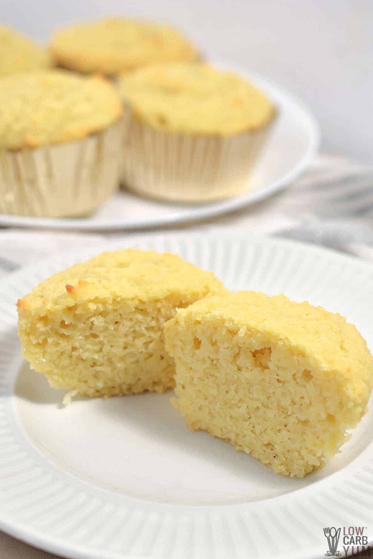cut muffin on white plate.