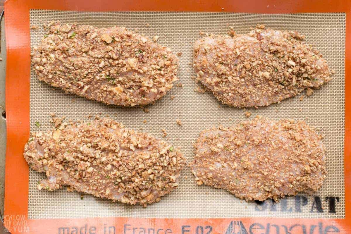 coated chicken breasts with pecan crumb mixture.