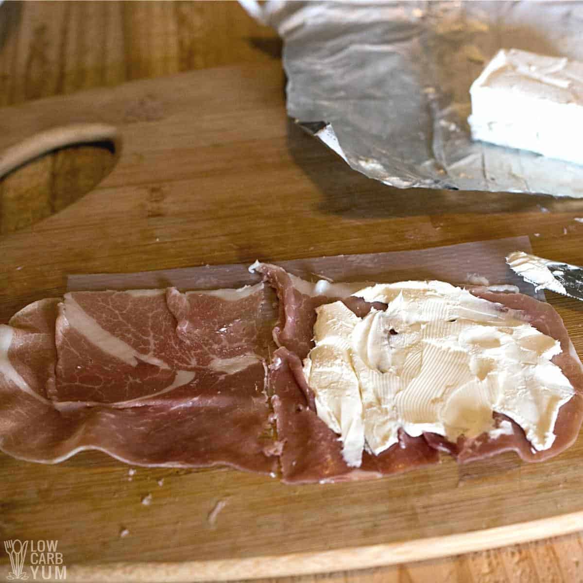 thin sliced ham with cream cheese spread on top