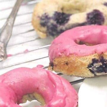 keto blueberry cake donuts on a cooling rack