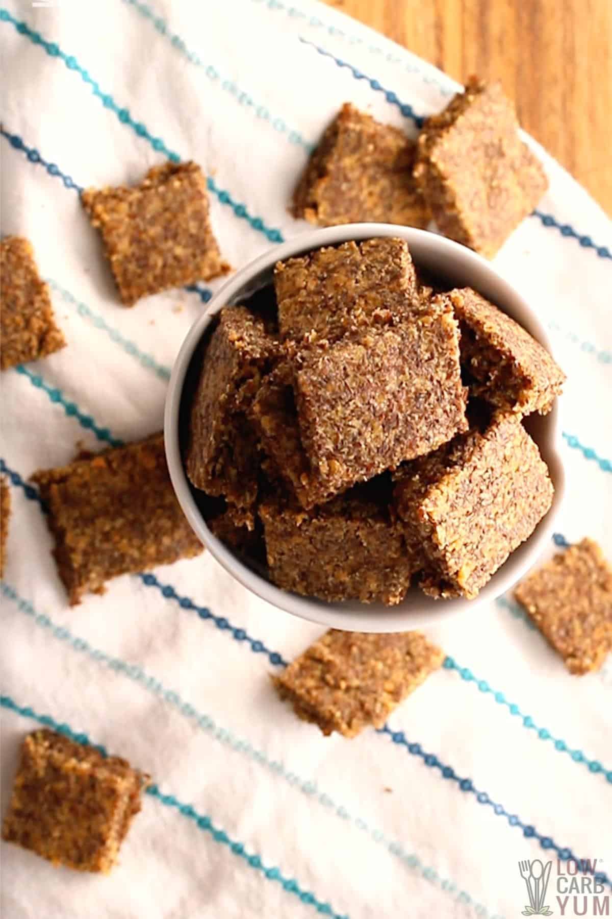 top view of flax seed crackers in white cup.