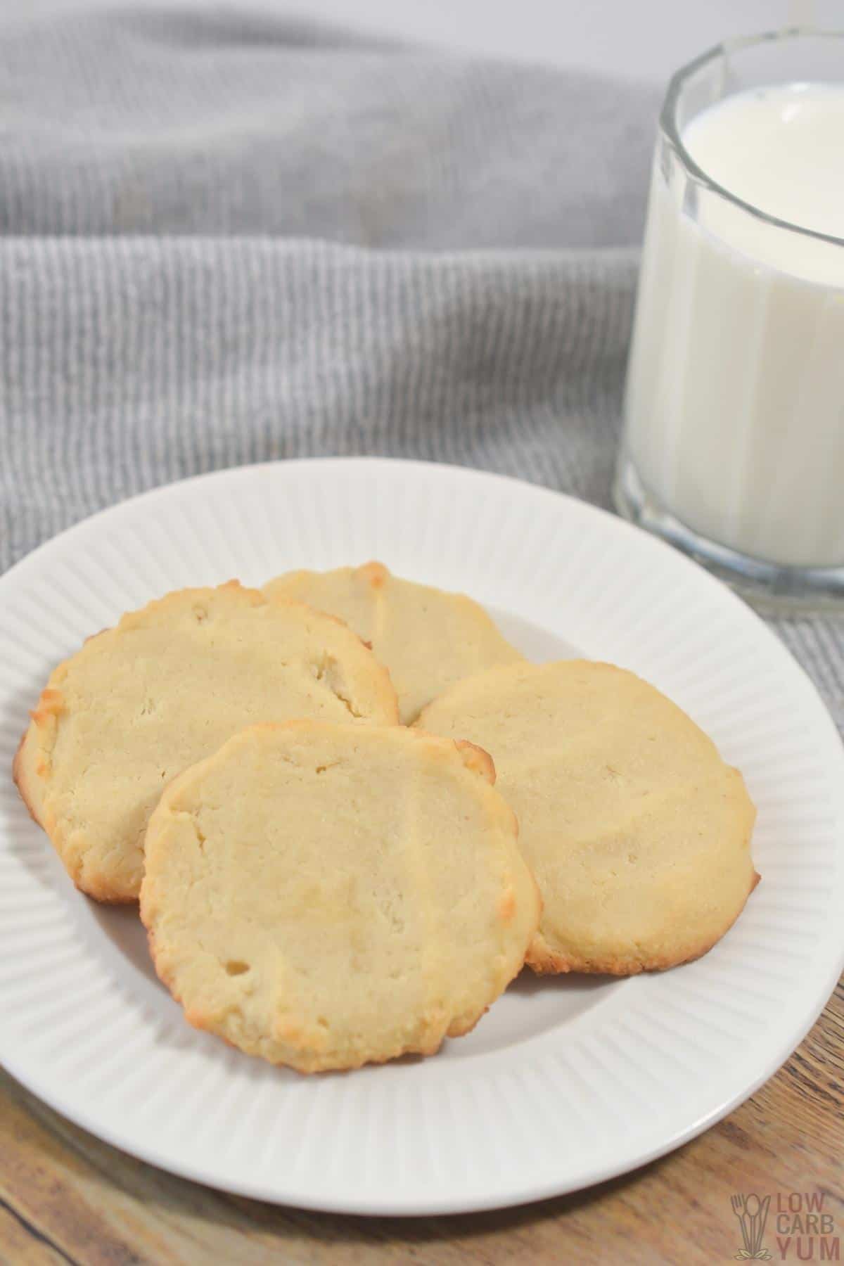 almond flour cookies on white plate with glass of milk.