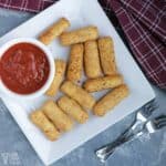 keto mozzarella cheese sticks on square white plate.