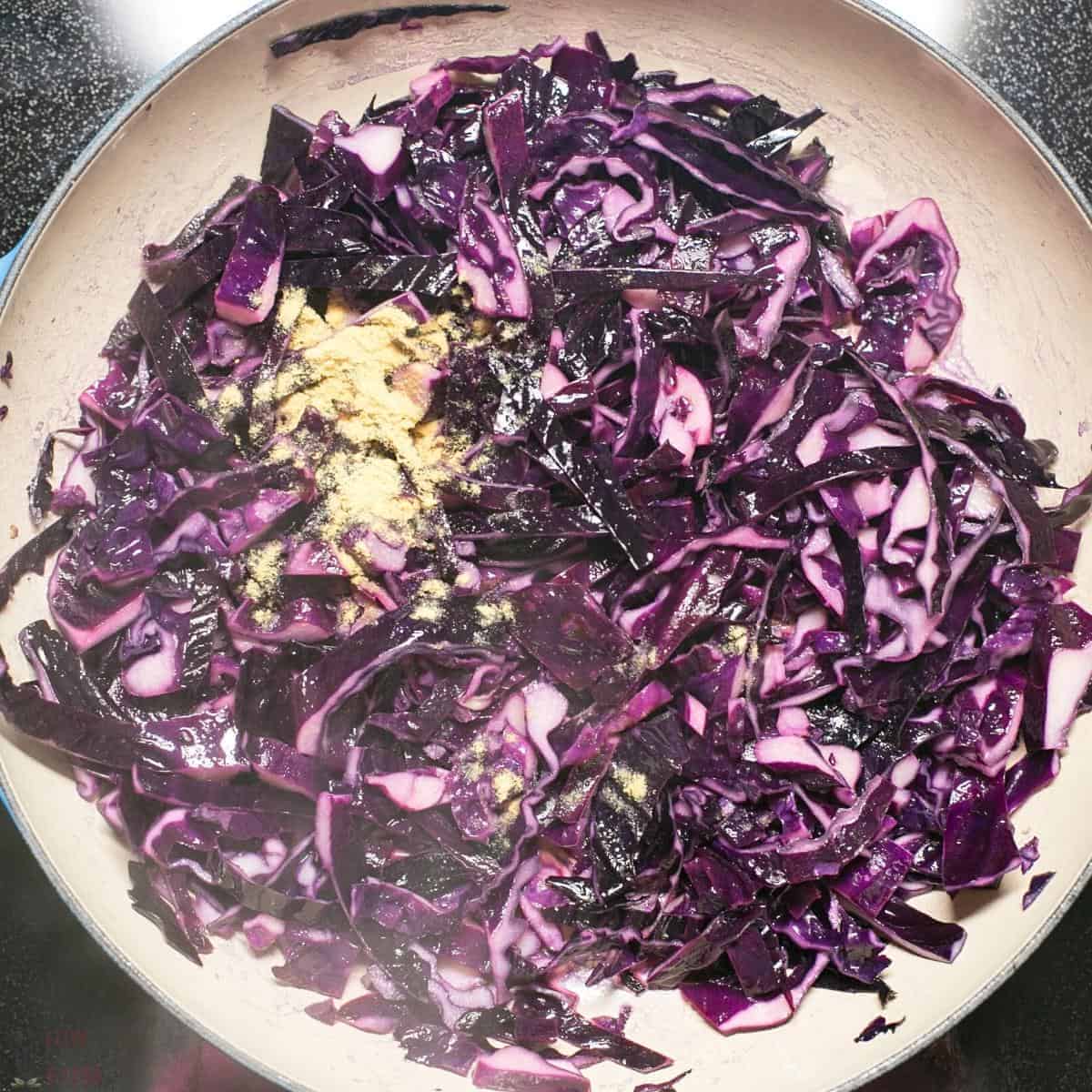 adding spices to cabbage.