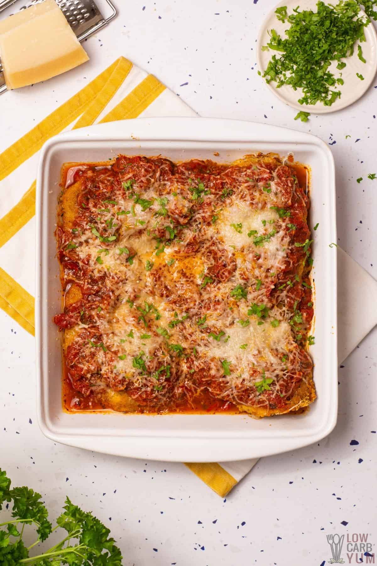 baked chicken parmesan in baking pan.