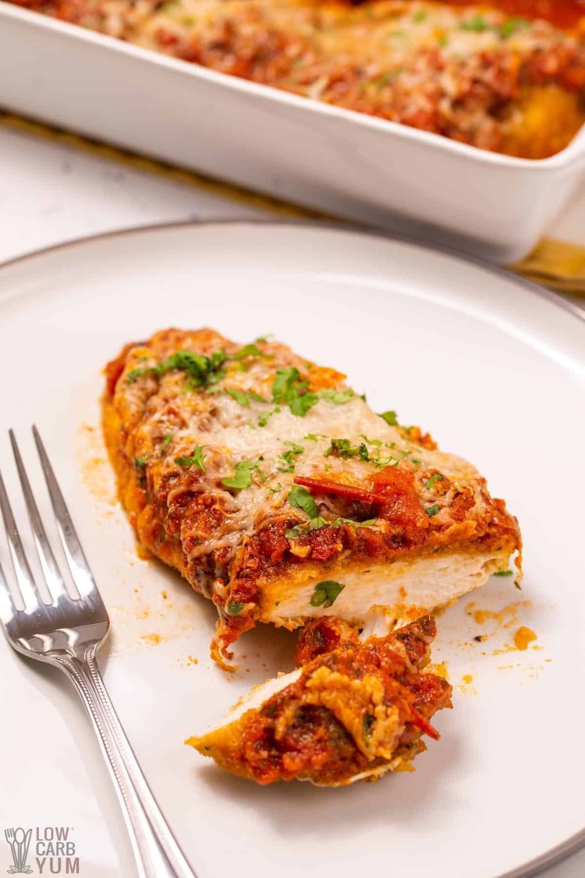 chicken parmesan sliced on plate to enjoy for proteins on keto diet