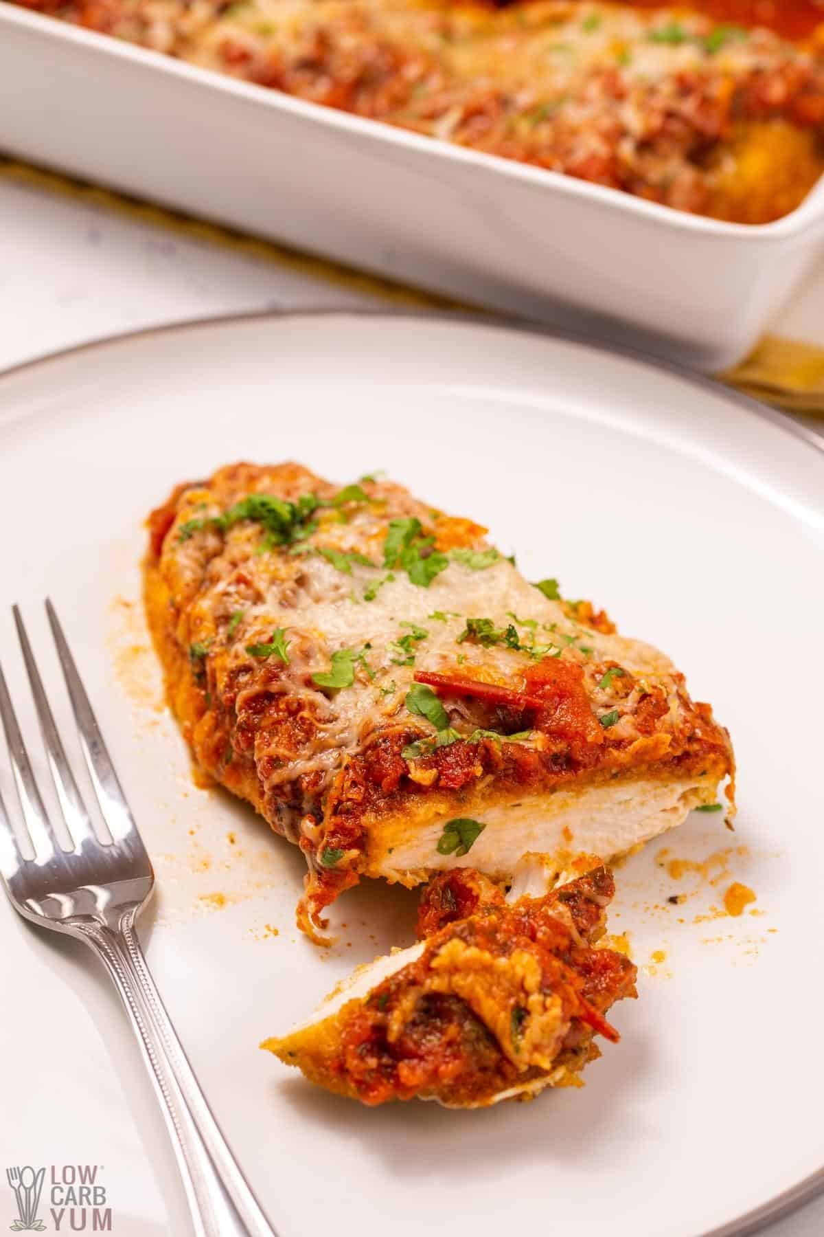 chicken parmesan sliced on plate.