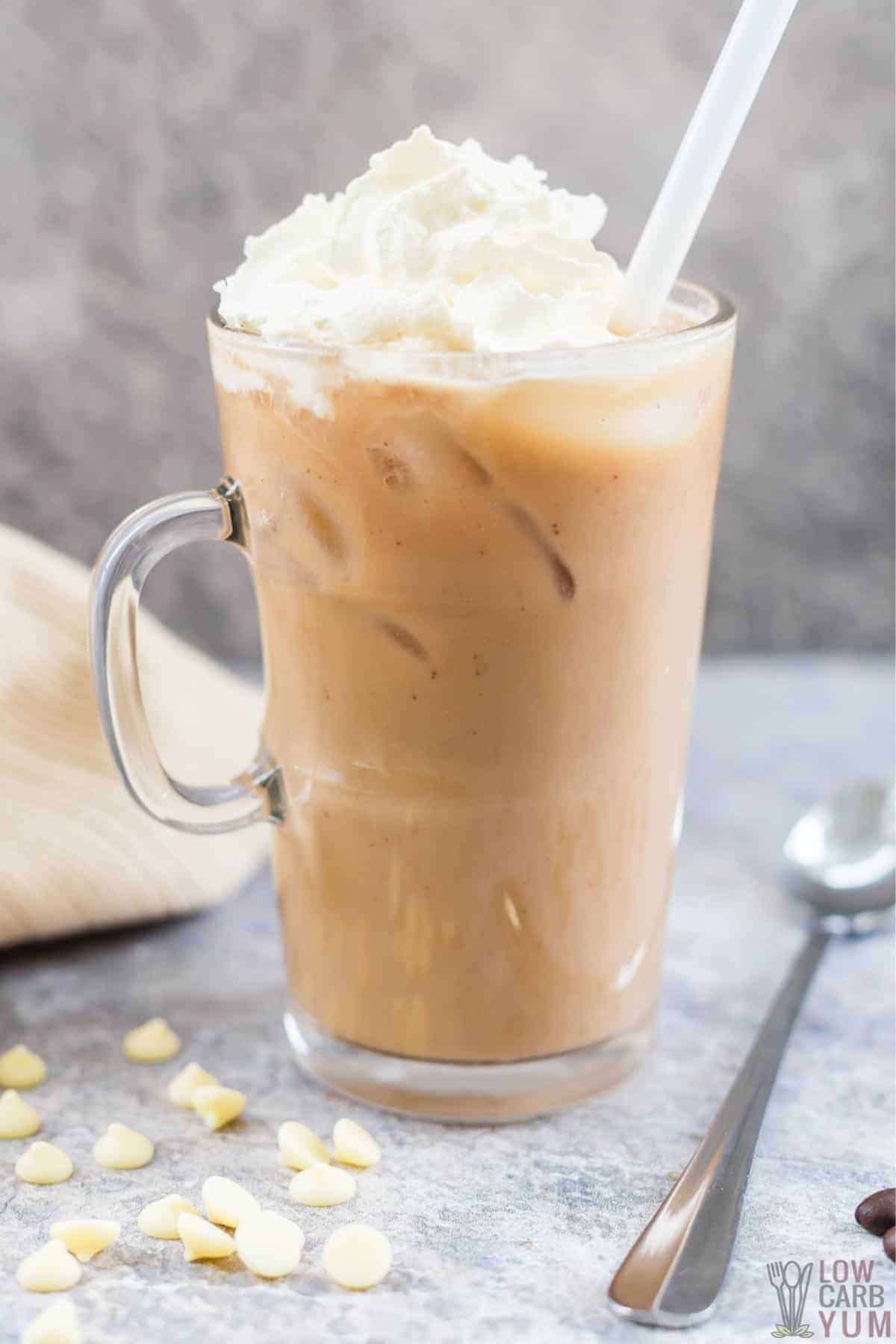 iced white chocolate mocha in glass mug with straw.