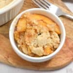 keto peach cobbler in white bowl.