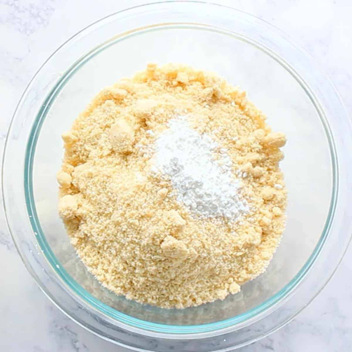almond flour and baking powder in glass mixing bowl.
